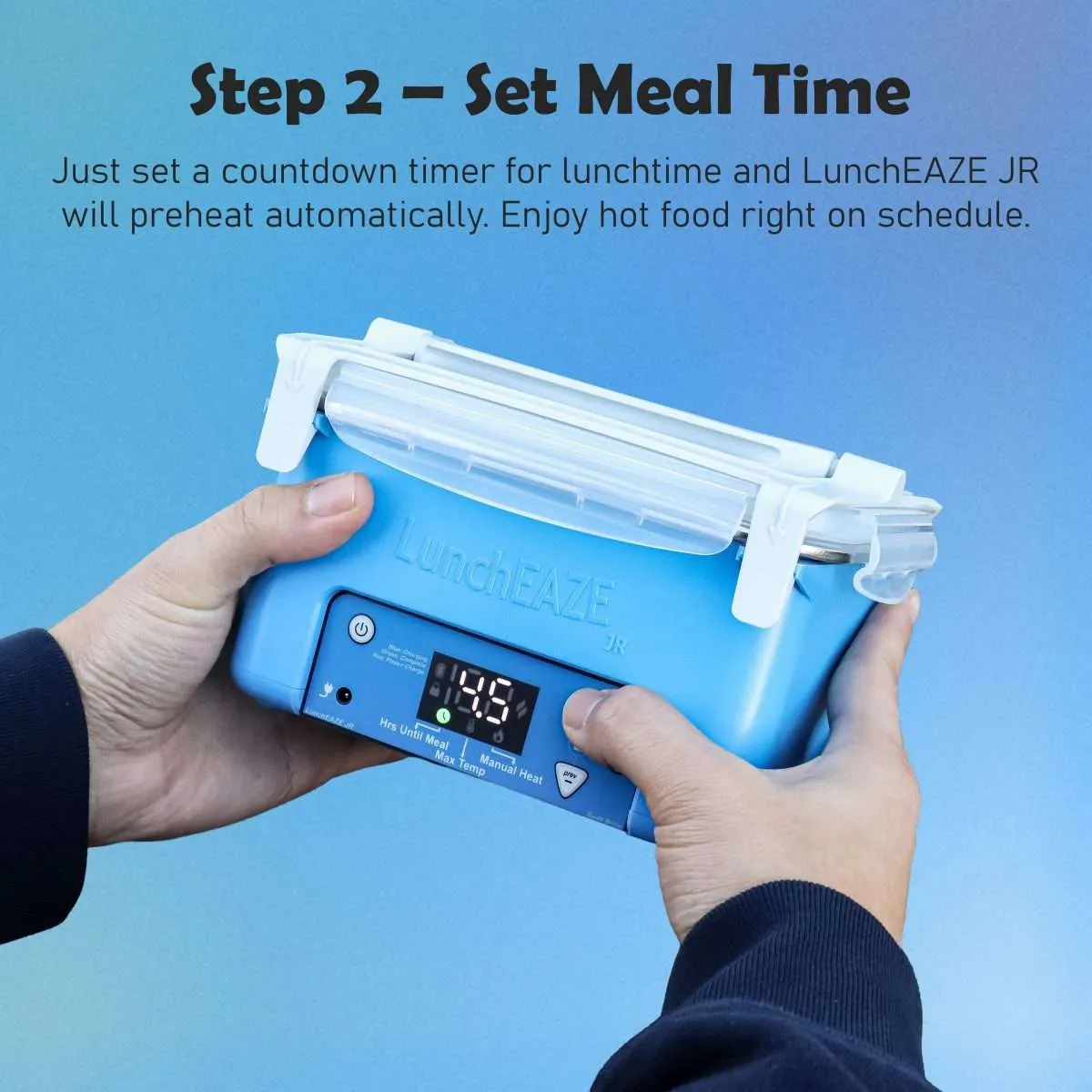 Hand holding blue Luncheaze JR Text reads: Step 2 – Set Meal Time Just set a countdown timer for lunchtime and LunchEAZE JRwill preheat automatically. Enjoy hot food right on schedule.