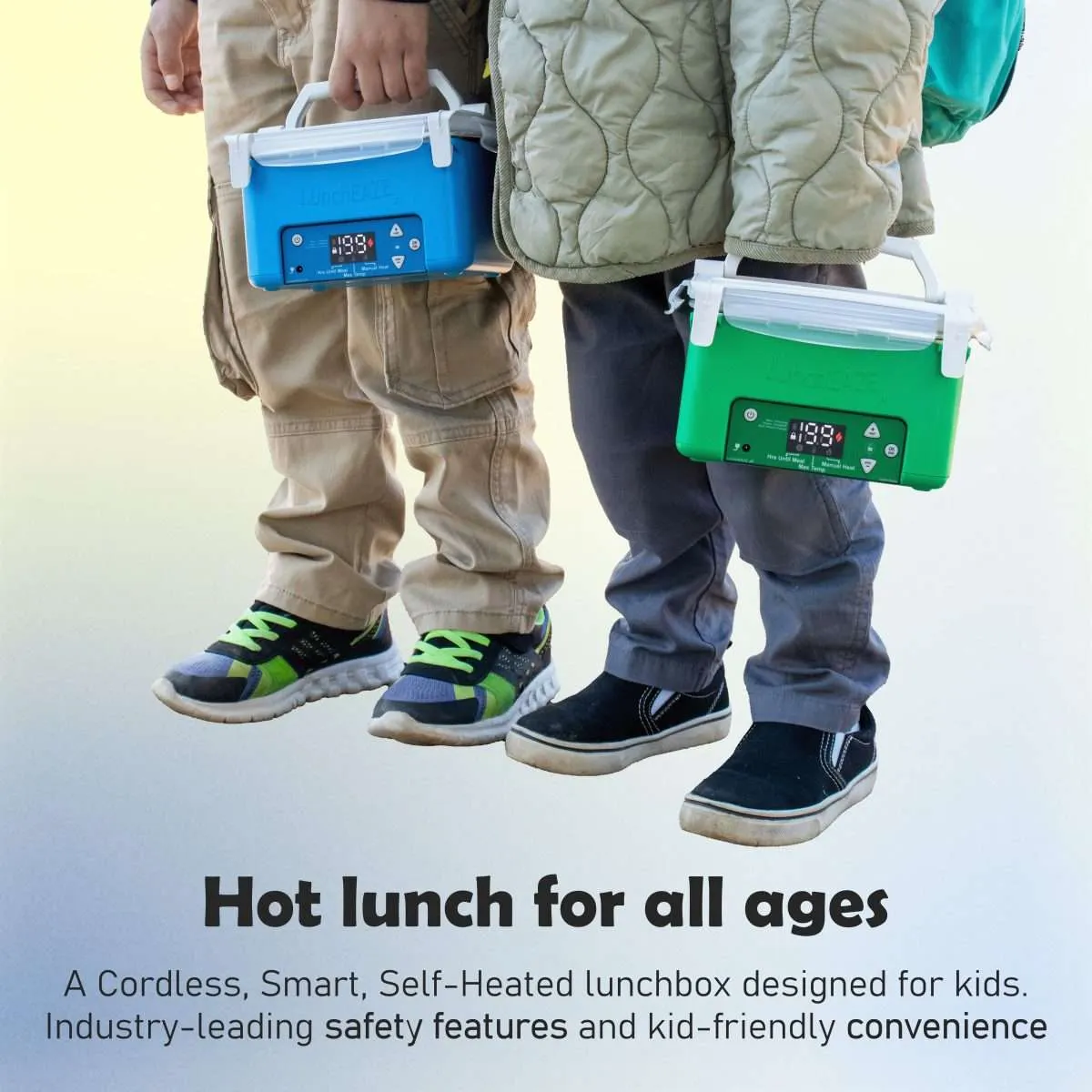 two children holding a LunchEAZE JR in blue and green Text reads: Hot lunch for all ages A Cordless, Smart, Self-Heated lunchbox designed for kids. Industry-leading safety features and kid-friendly convenience