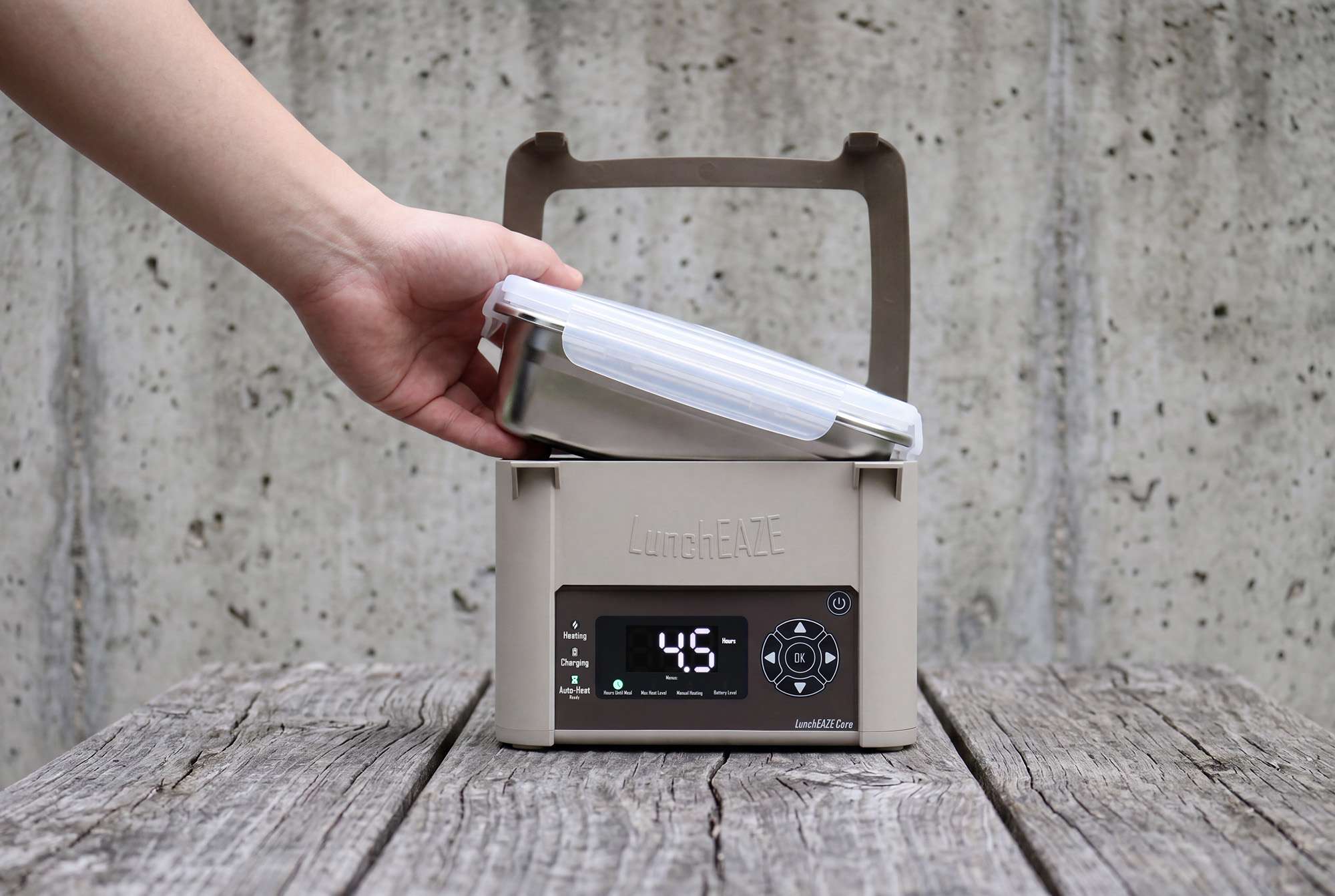 Hand inserting removable container into LunchEAZE Core